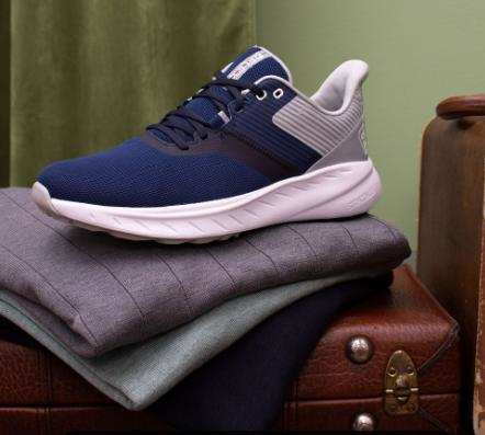 Side view of navy and white Footjoy golf shoes.